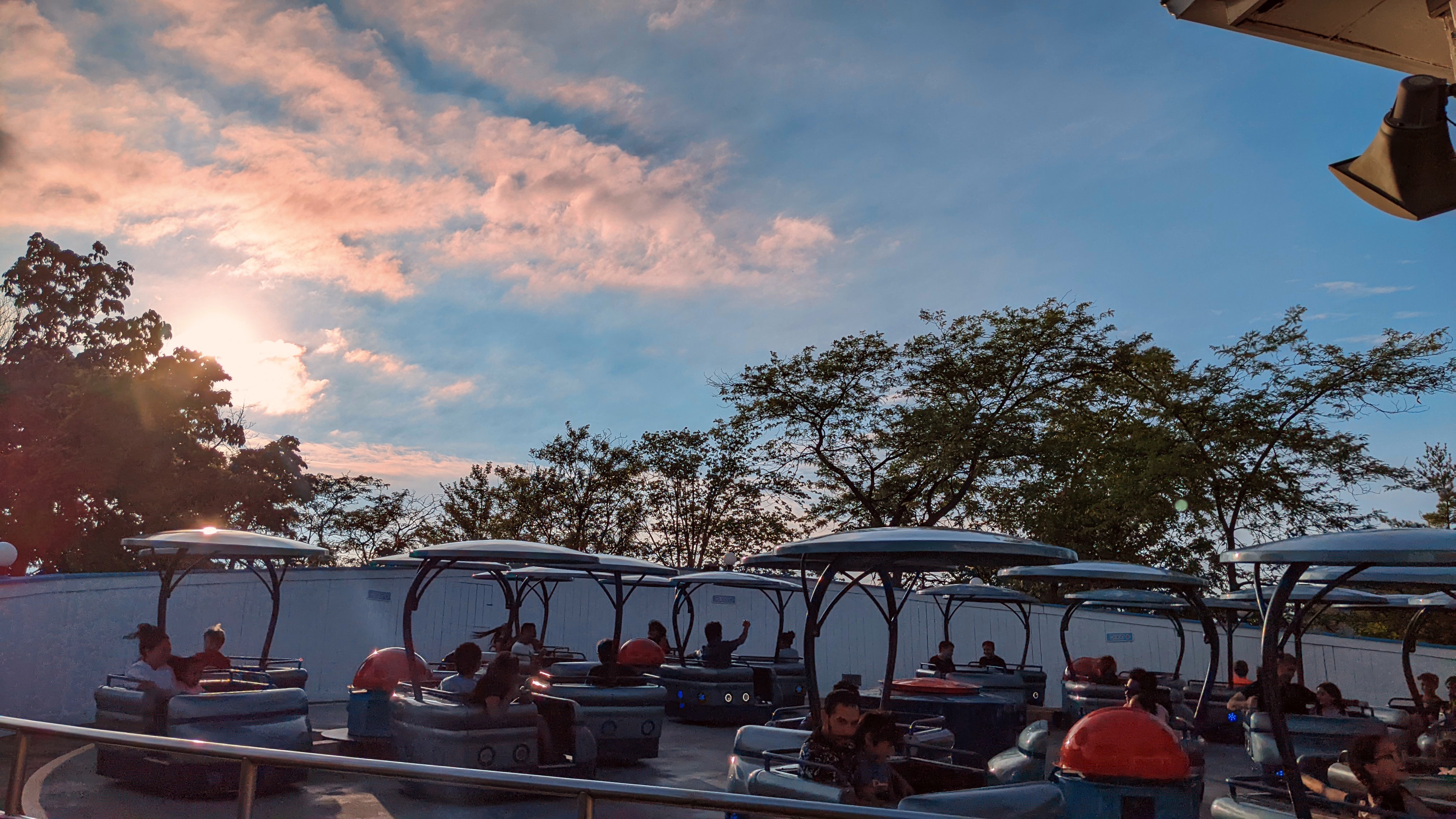 The sun sets behind a theme park memory