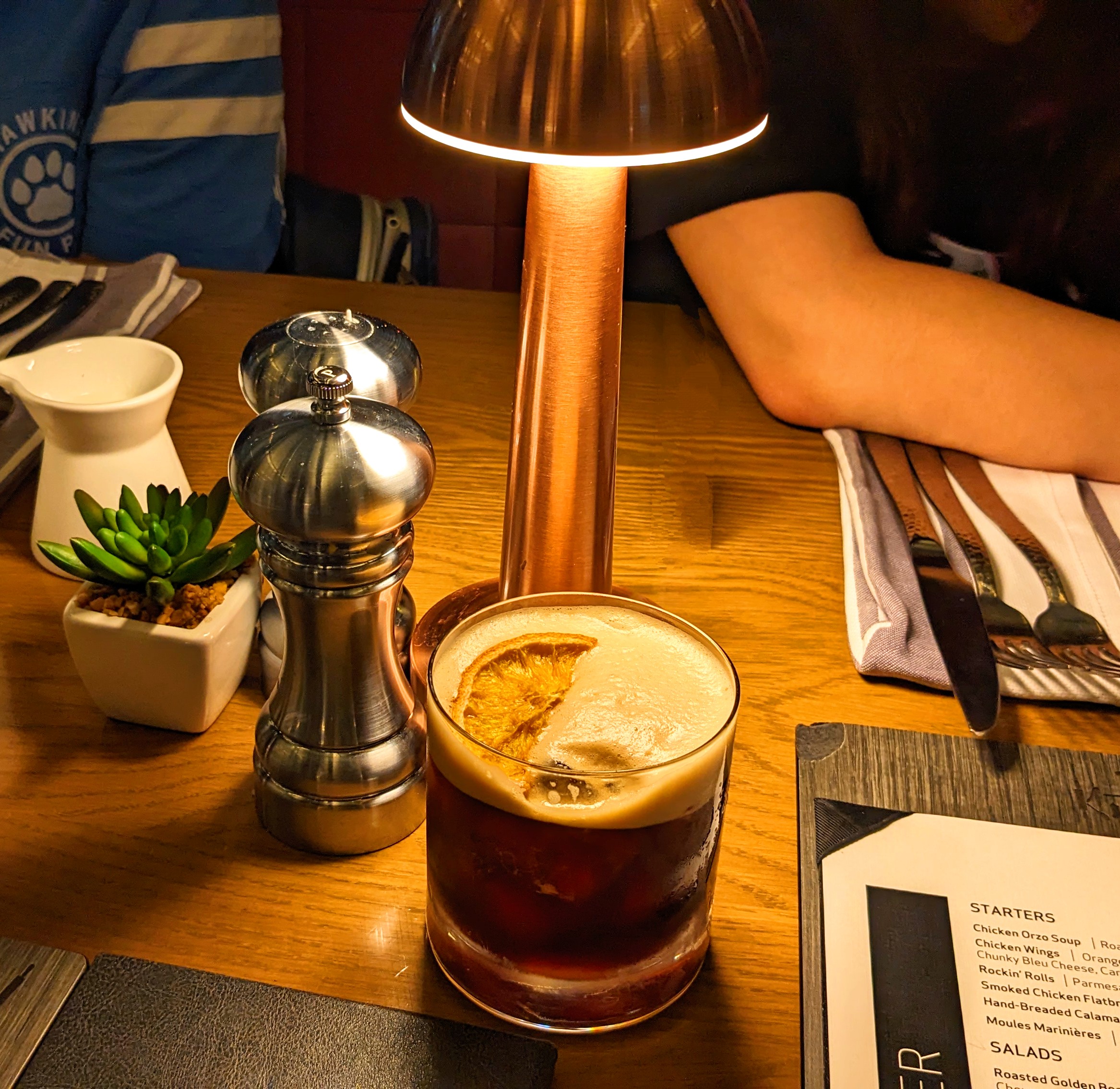 A beverage served before dinner on a wood table