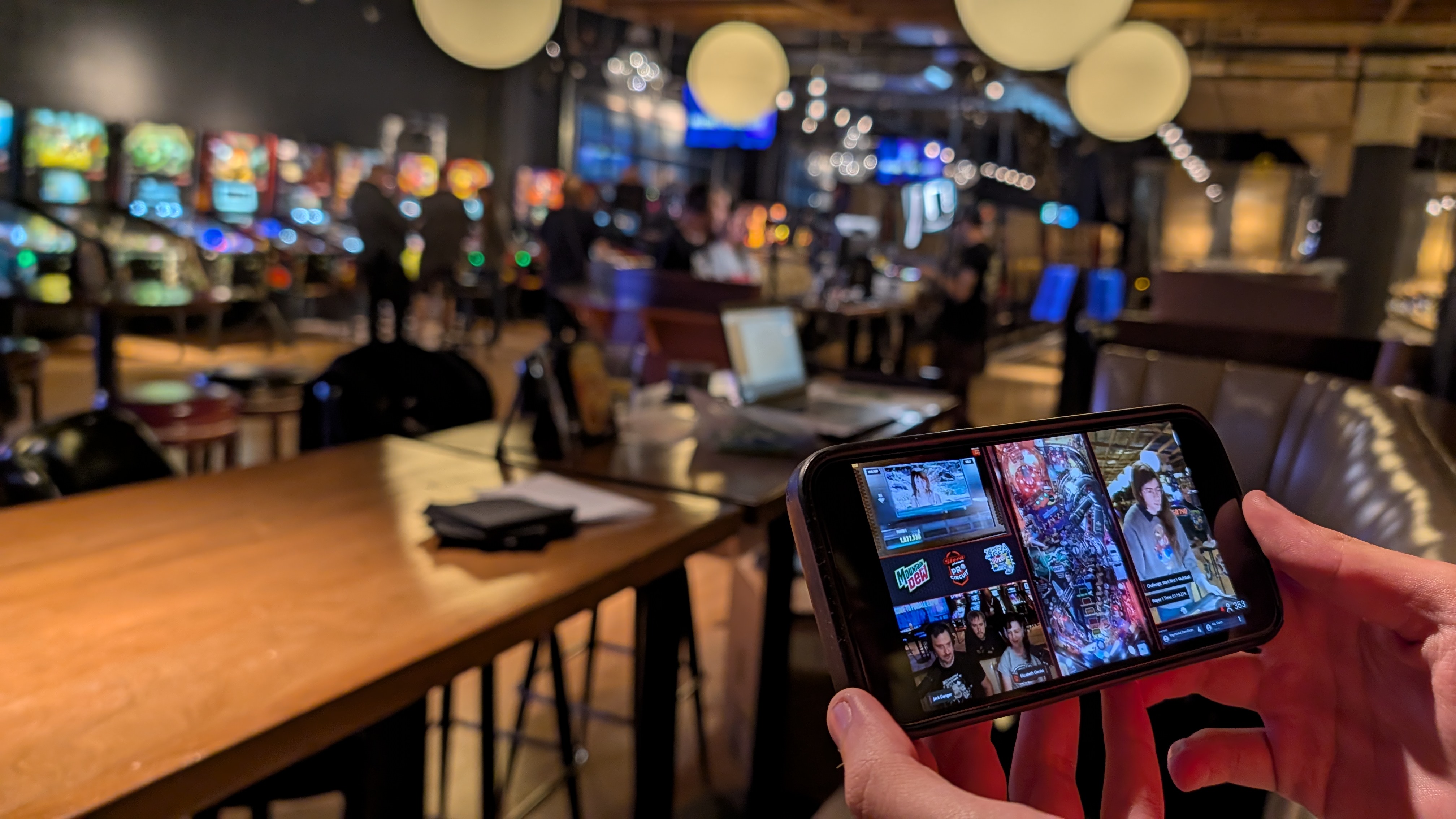 A livestream watched on a phone as it is recorded in the background