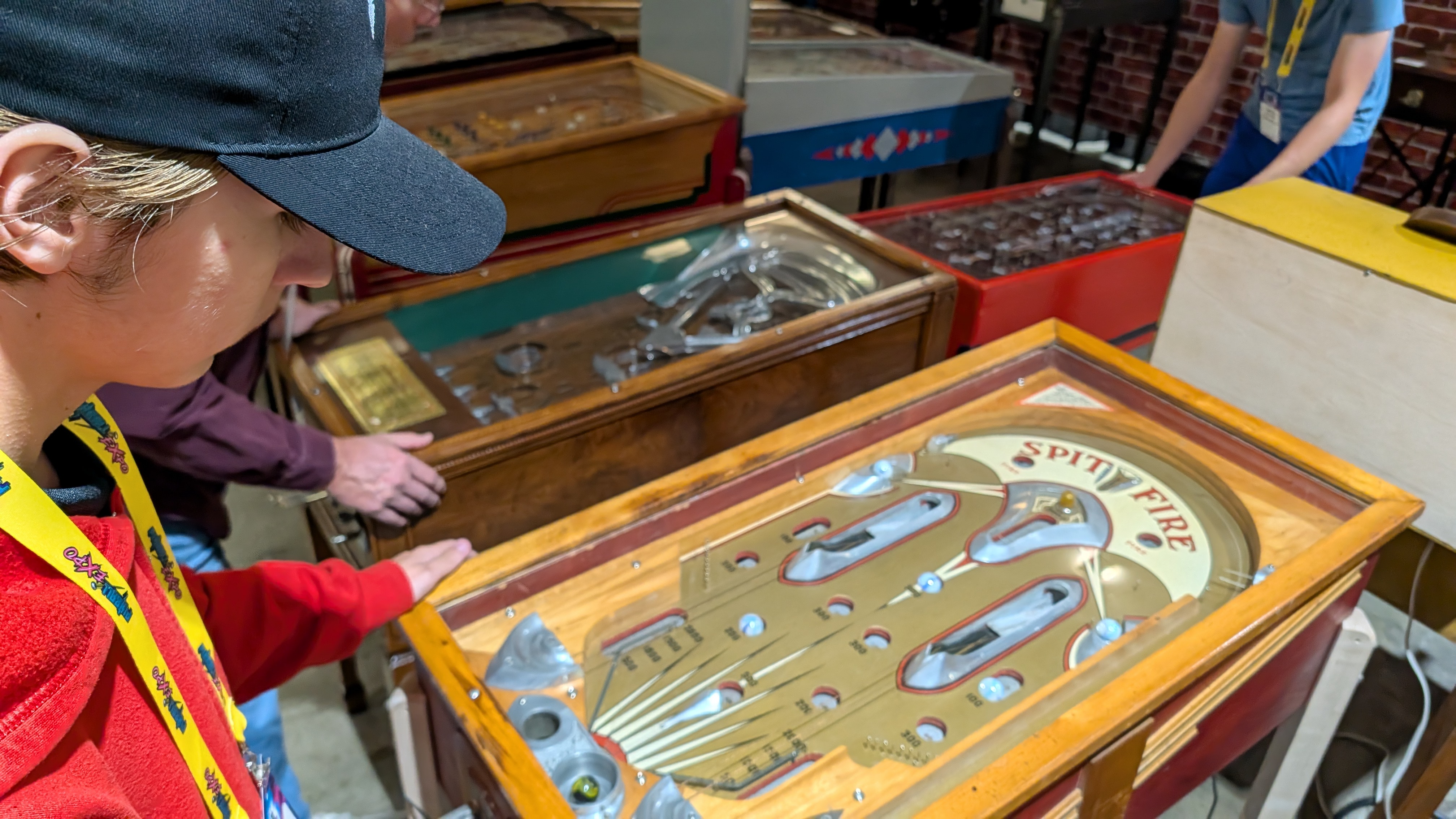 Young guy plays a pinball machine made circa 1930