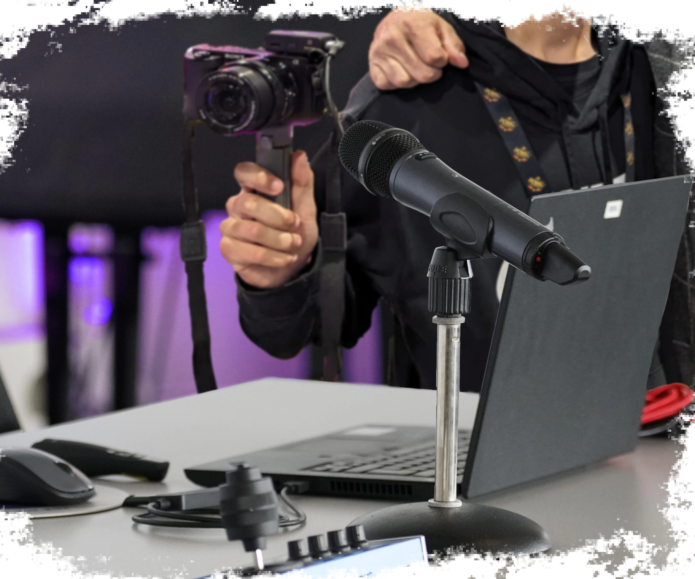 Camera man standing behind a podcast setup